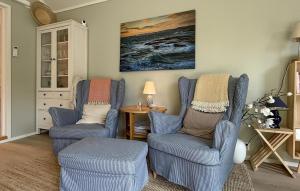 a living room with two chairs and a table at 2 Bedroom Beautiful Home In Gressvik in Slevik