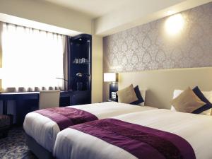 Ένα ή περισσότερα κρεβάτια σε δωμάτιο στο Mercure Sapporo +152 φωτογραφίες