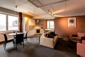 a living room with a couch and a table at Scandic Syv Søstre in Sandnessjøen