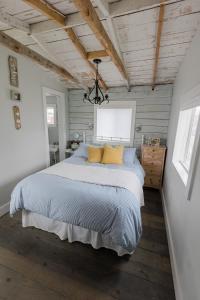 a bedroom with a large bed and a chandelier at Starfish Cottage in Peggy's Cove