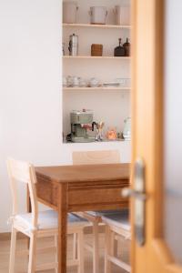 a dining room table with two chairs and a machine on a shelf at Tirituffo - B&B di campagna in Soveria Mannelli