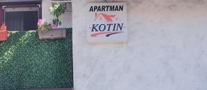 a sign on the side of a building at Apartman Kotin in Pirot