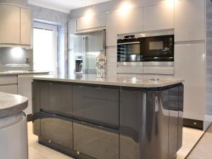 a kitchen with stainless steel appliances and a large island at Fernhill Cottage in Oxenhope