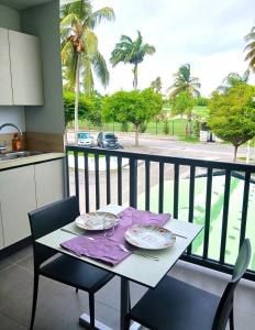 a table with two plates on it on a balcony at Golf Marin in Saint-François