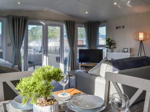 a living room with a couch and a table at Lodge 42 Bridlington Holiday Park - Uk48213 in Carnaby
