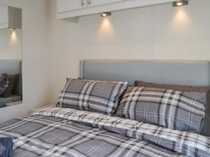 a bed with two pillows on top of it at Lodge 42 Bridlington Holiday Park - Uk48213 in Carnaby