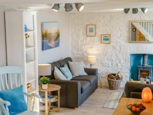 a living room with a couch and a fireplace at Bon Accorde in Goodwick