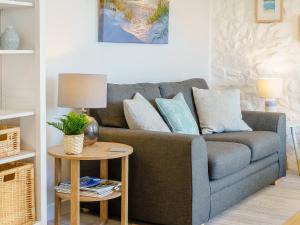 a living room with a couch and a table at Bon Accorde in Goodwick