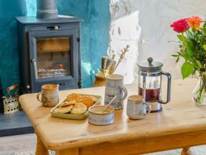 a table with a plate of bread and a stove at Bon Accorde in Goodwick