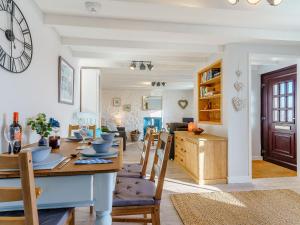 a dining room and living room with a table and chairs at Bon Accorde in Goodwick +27 photos