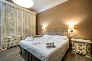 a bedroom with a large bed with towels on it at YD penthouse Torregalli in Scandicci
