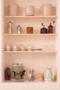 a kitchen shelf filled with dishes and a coffee maker at Tirituffo - B&B di campagna in Soveria Mannelli