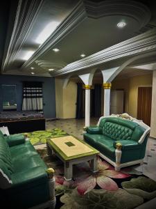 a living room with a green couch and a table at Peace&Love in Cotonou