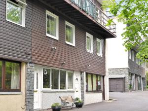 a wooden building with a bench in front of it at Belle View - 26645 in Bowness-on-Windermere