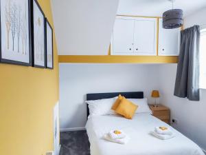 a bedroom with a bed with two towels on it at Belle View - 26645 in Bowness-on-Windermere +8 photos