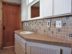 a bathroom with a sink and a mirror at The McCloud Vacation Home on Mt Shasta, Sleeps 13 in McCloud +50 photos