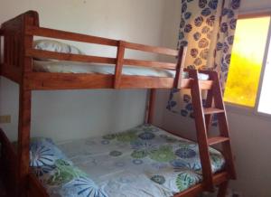 a bedroom with two bunk beds in a room at Uncle Bob&Tere's Beachfront House in Luna