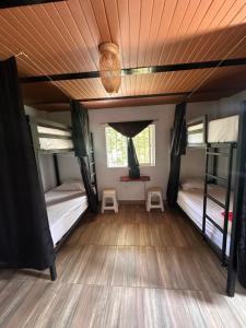a room with two bunk beds and a wooden floor at Maracuya Hostel in San Rafael