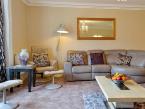 a living room with a couch and a table at Maesbangor Farmhouse in Capel Bangor