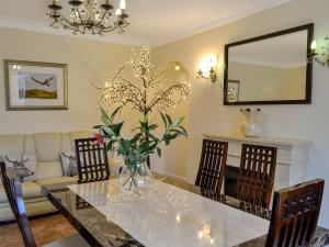 a living room with a table and a couch at Maesbangor Farmhouse in Capel Bangor