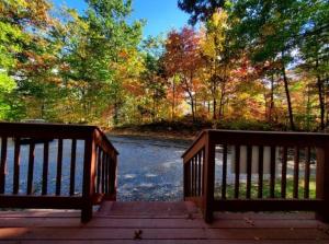 a wooden bridge over a river with trees in the background at Gatlinburg Mountain Cabin with Modern Comforts in Chalet Village