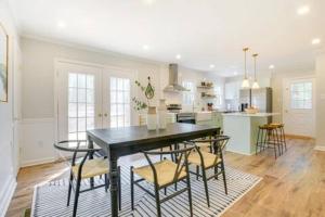 a kitchen and dining room with a black table and chairs at Serene 3 bedroom home in Apex in Apex