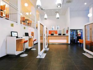 a lobby of a hospital with a desk and chairs at Ibis budget Wien Messe in Vienna