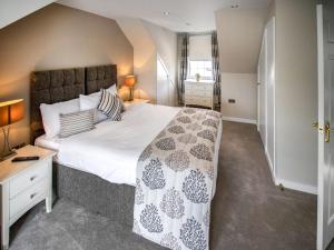 a bedroom with a large bed and a desk at The Loans Inn Cottage in Loans