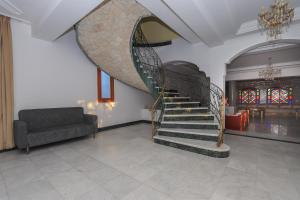 a spiral staircase in a living room with a couch at Luxury Villa 4-Bedroom Estate with Panoramic Tanger Bay Sea View, Private Pool, Garden in Noûnouech +54 photos