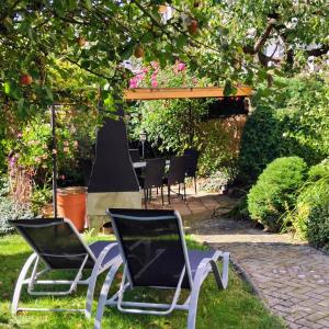 two chairs and a table in a garden at Apartmán Slunečná in Moravská Třebová
