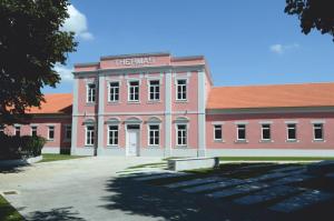 a large red building with ainders sign on it at Quatro Ponto Cinco in Caldelas