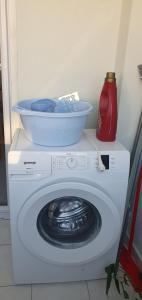 a washing machine with a bowl on top of it at Apartment 7 in Tisno +1 photo