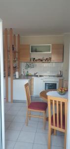 a kitchen with a table and two chairs and a table at Apartment 7 in Tisno