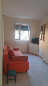 a living room with a couch and a table at Apartment 7 in Tisno