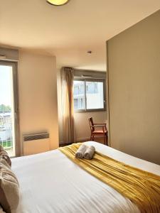 Ένα ή περισσότερα κρεβάτια σε δωμάτιο στο Le Saint Jean, Ouest de Rennes, avec balcon et stationnement