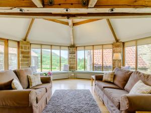 a large living room with couches and windows at The Wheel House in Potto