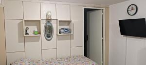 a room with a tv and a door with a bed at PRATE48 in Bologna