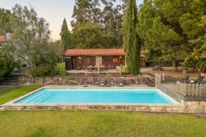 a swimming pool in the backyard of a house at Portugal Active São Julião Retreat | Pool, Jacuzzi & Garden Escape in Mato