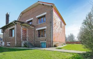 an old brick building with a blue door at Havre De Paix À La Campagne in Lebiez +25 photos