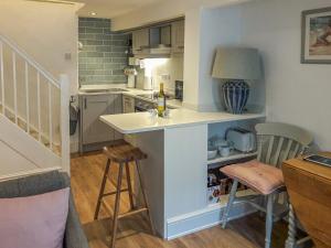 a kitchen with a island in the middle of a room at Silver Cottage in Dartmouth
