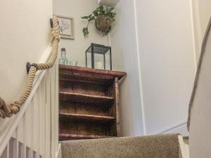 a set of stairs with a wooden stair case at Silver Cottage in Dartmouth