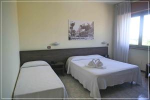 a hospital room with two beds and a window at Hotel I Cugini in Castelfidardo