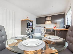 a dining room with a glass table and chairs at Flat 1 in Inverness