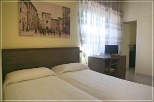 Кровать или кровати в номере Hotel I Cugini