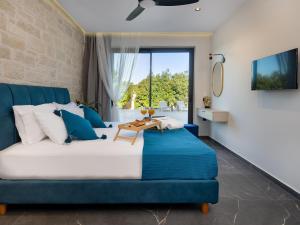 a bedroom with a blue couch and a table at PanStel Twin Villas with private pools and jacuzzi in Ayiá