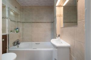 a bathroom with a tub and a toilet and a sink at Amazing Studio in Central London - 6 in London