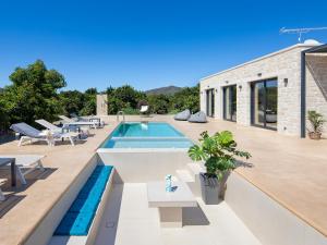 a house with a swimming pool and a patio at PanStel Twin Villas with private pools and jacuzzi in Ayiá