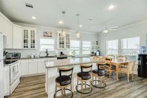 a kitchen with white cabinets and a table and chairs at Purple Paradise Beachy Fun Bay Beach Views in Hercules Offshore Heliport