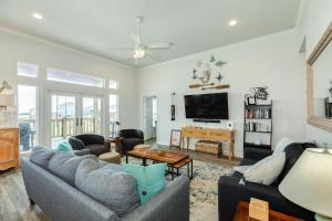 a living room with two couches and a flat screen tv at Purple Paradise Beachy Fun Bay Beach Views in Hercules Offshore Heliport