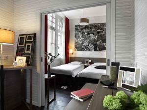 Postel nebo postele na pokoji v ubytování Aparthotel Adagio Strasbourg Place Kleber